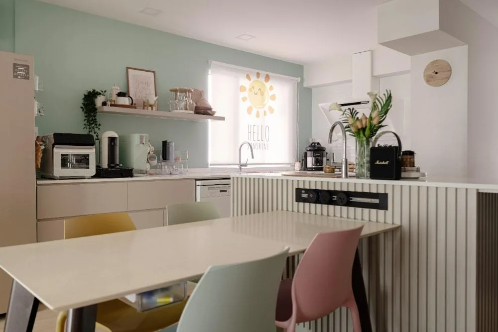 Open concept kitchen and dining space in pastel hues