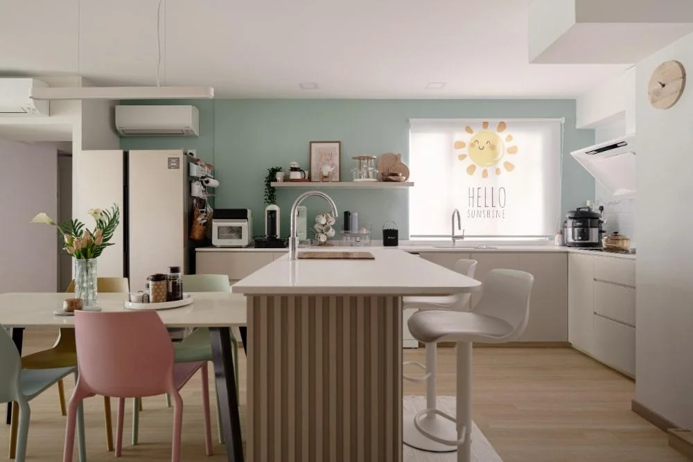 Open concept kitchen and dining space in pastel hues