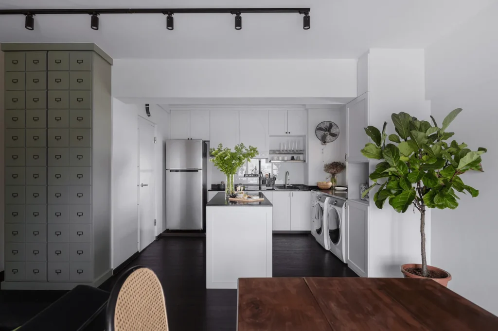 White kitchen and dining area with black, brown, and green contrasts